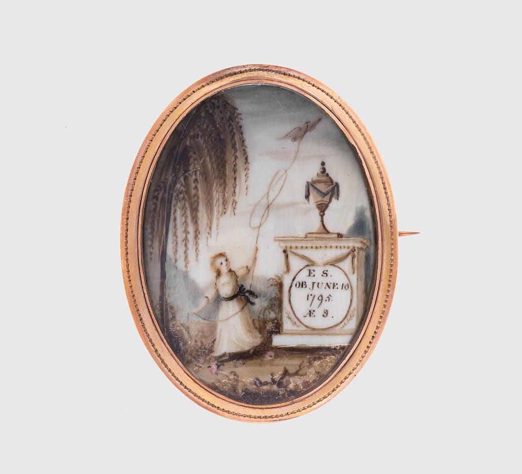 The frame is itself part of the artwork , gold, personal, wearable , transforming the painted image into a bodily act of mourning worn close to the heart