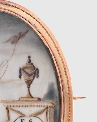 Classical mourning symbol; its prominence relative to the small girl underscores that this is a memorial, not a simple portrait