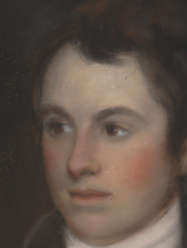 Soft light illuminates his face from the side.