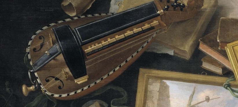 A hurdy-gurdy sits beside scattered books.