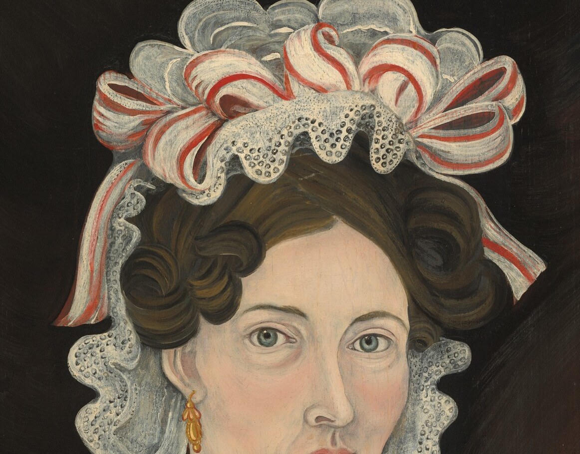 An elaborate bonnet. Lace and ribbons were costly.