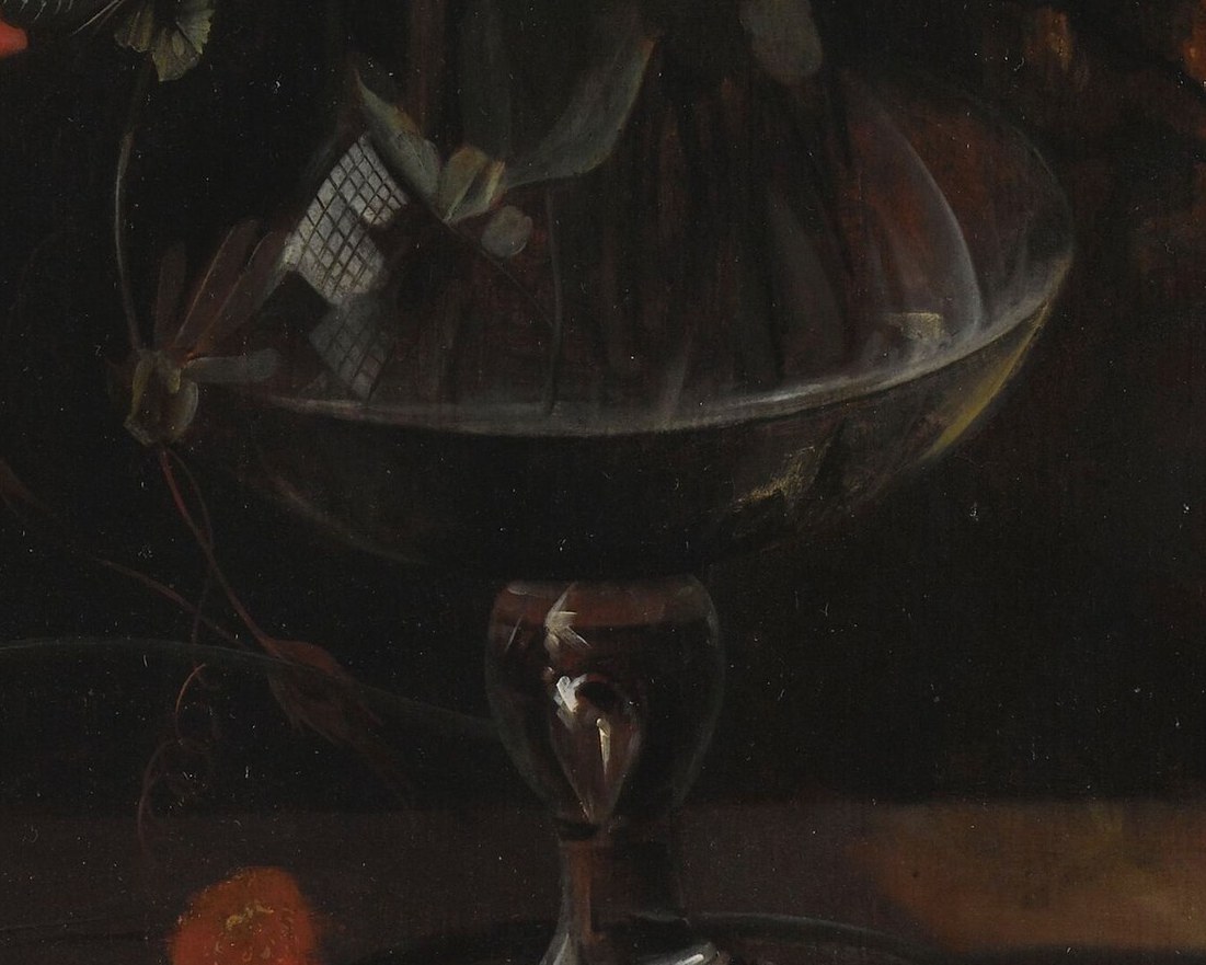 Look closely at the table, by the glass vase.