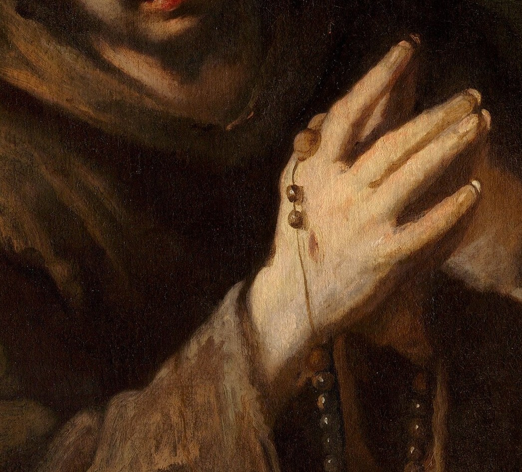 Clasped together, they show the physical act of devotion and prayer, with rosary beads slipping through.