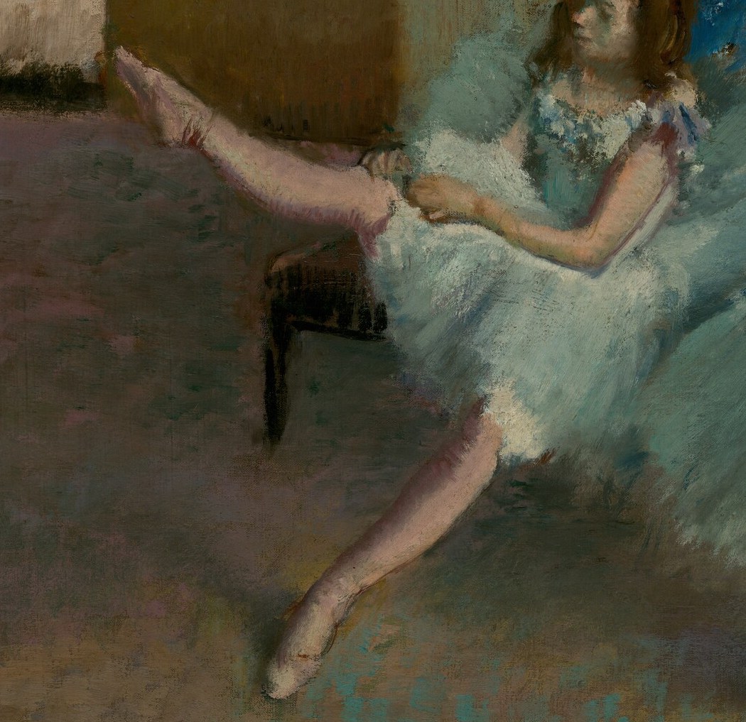 The dynamic pose highlights the dancer's flexibility and the rigorous training involved.