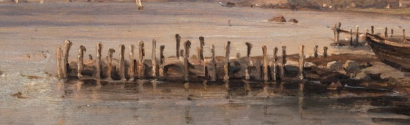 The weathered posts create a rhythmic pattern, hinting at past use and the passage of time.