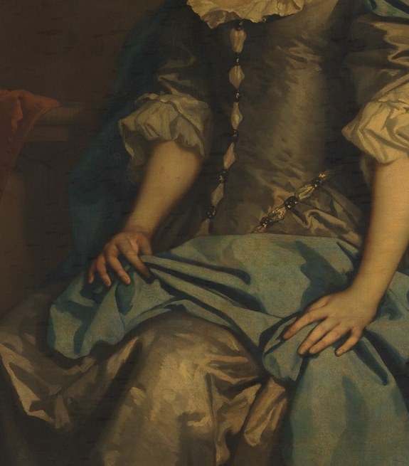 The gold trim on the bodice signals staggering expense , this dress alone encoded her royal patronage more clearly than any inscription