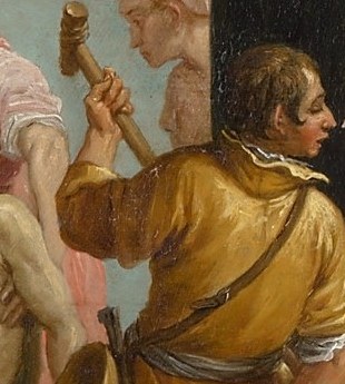 Among the crowd, a man holds a hammer.