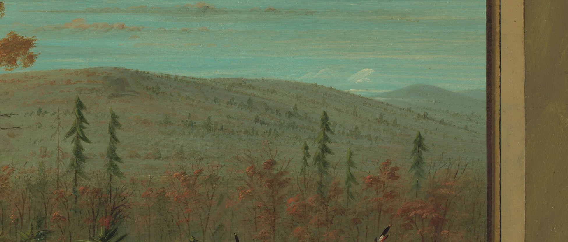 The subdued colors and hazy atmosphere of the background hills create a sense of depth and vastness of the landscape.