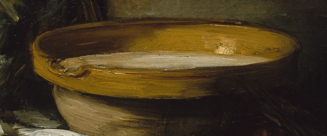 The vibrant yellow of the bowl and the subtle reflection of light on the liquid create a focal point.