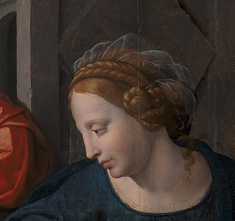 Mary gently holds her infant son, an image of tenderness.