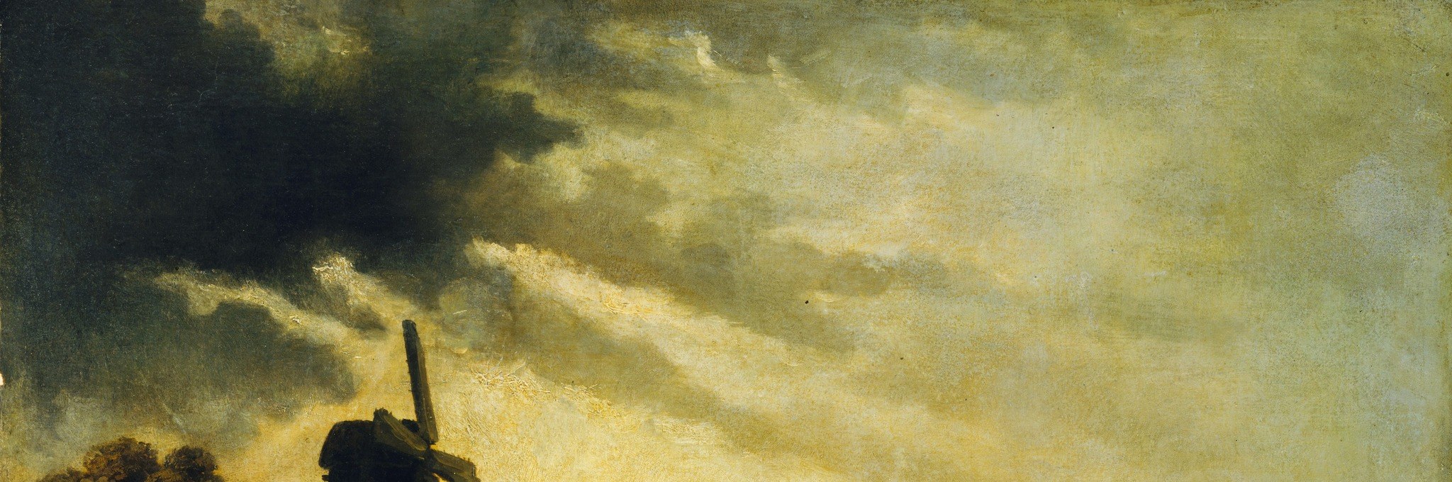 The dramatic, cloud-filled sky creates a sense of atmosphere and foreboding, contrasting with the sunlit landscape below.