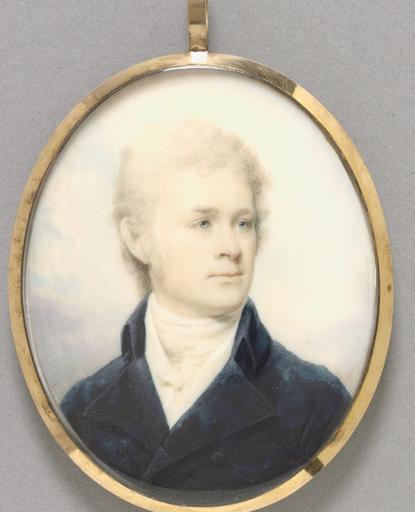 The warm, metallic sheen of the frame encloses the portrait, emphasizing its preciousness as a miniature.