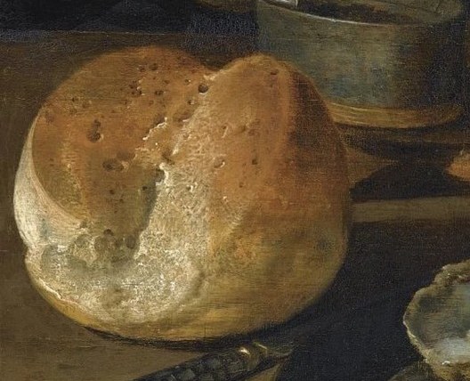 The texture of the bread, with its rough crust and soft interior, invites a tactile response from the viewer.
