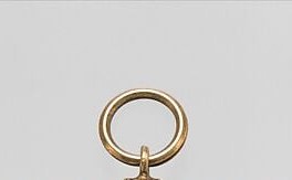 The gold ring at the top makes it wearable, carried against the body.