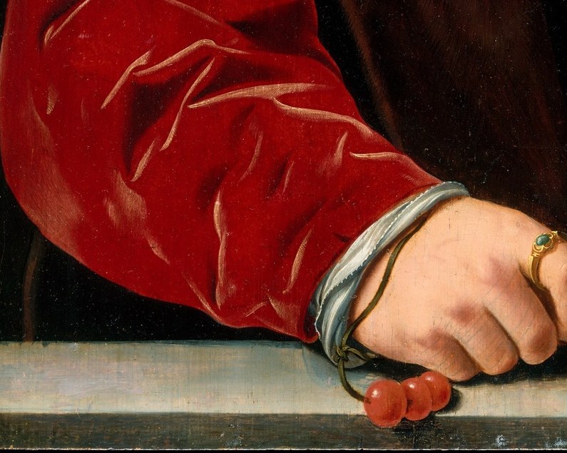 His left hand holds a rosary. A Catholic declaration.