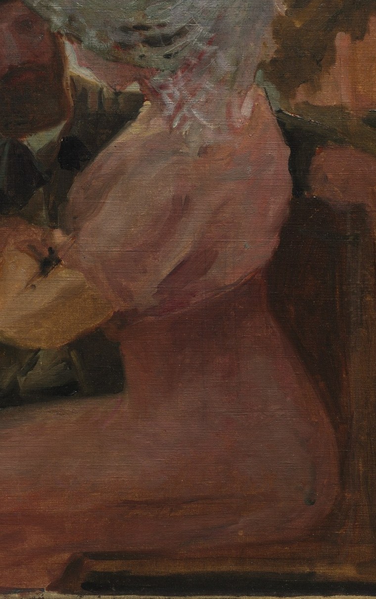 A woman in a pink dress watches the water.