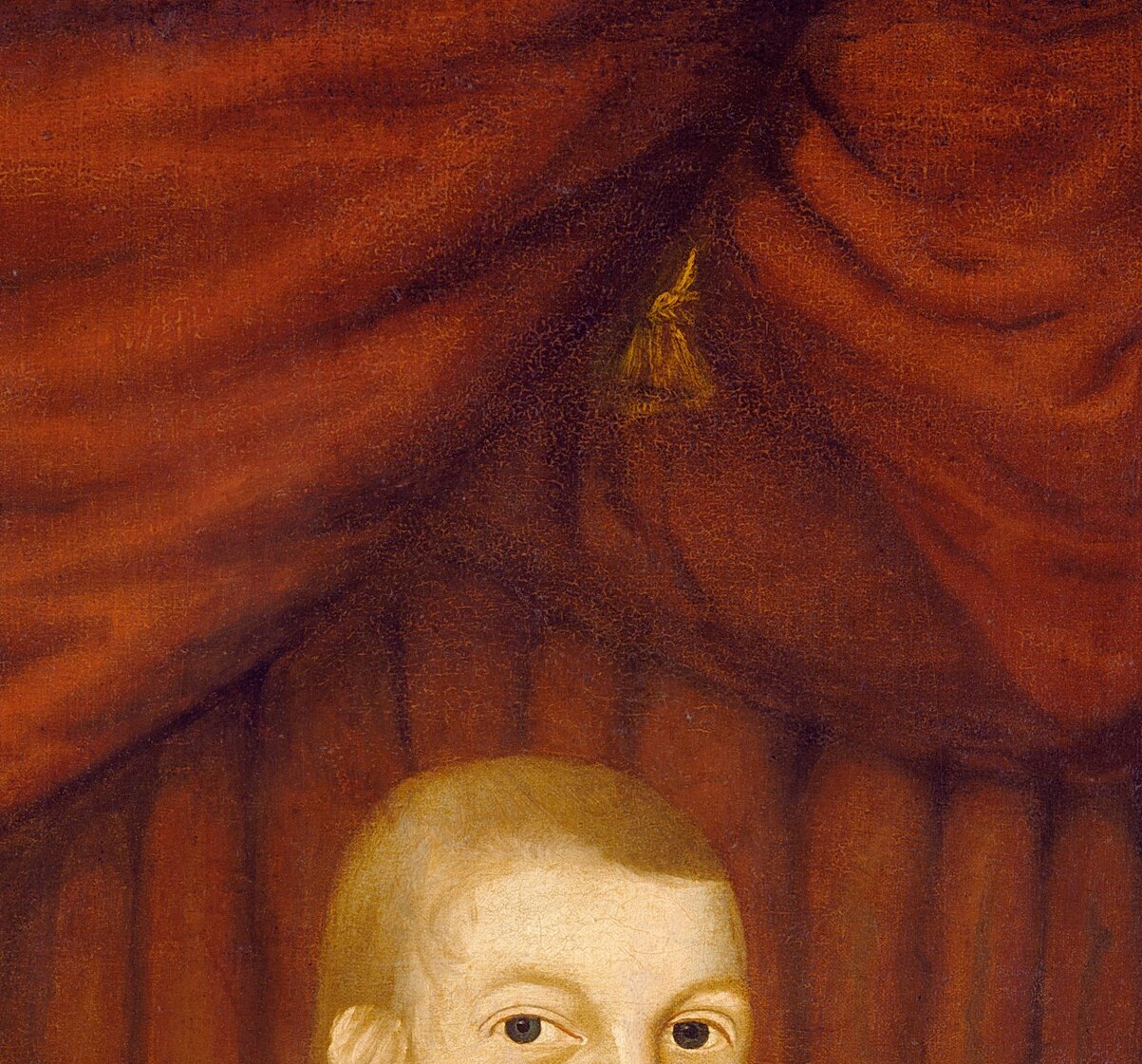 The boy stares straight ahead, solemn as a man.
