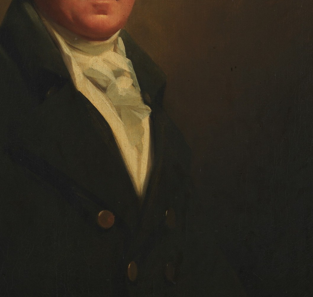 The dark coat suggests his status.