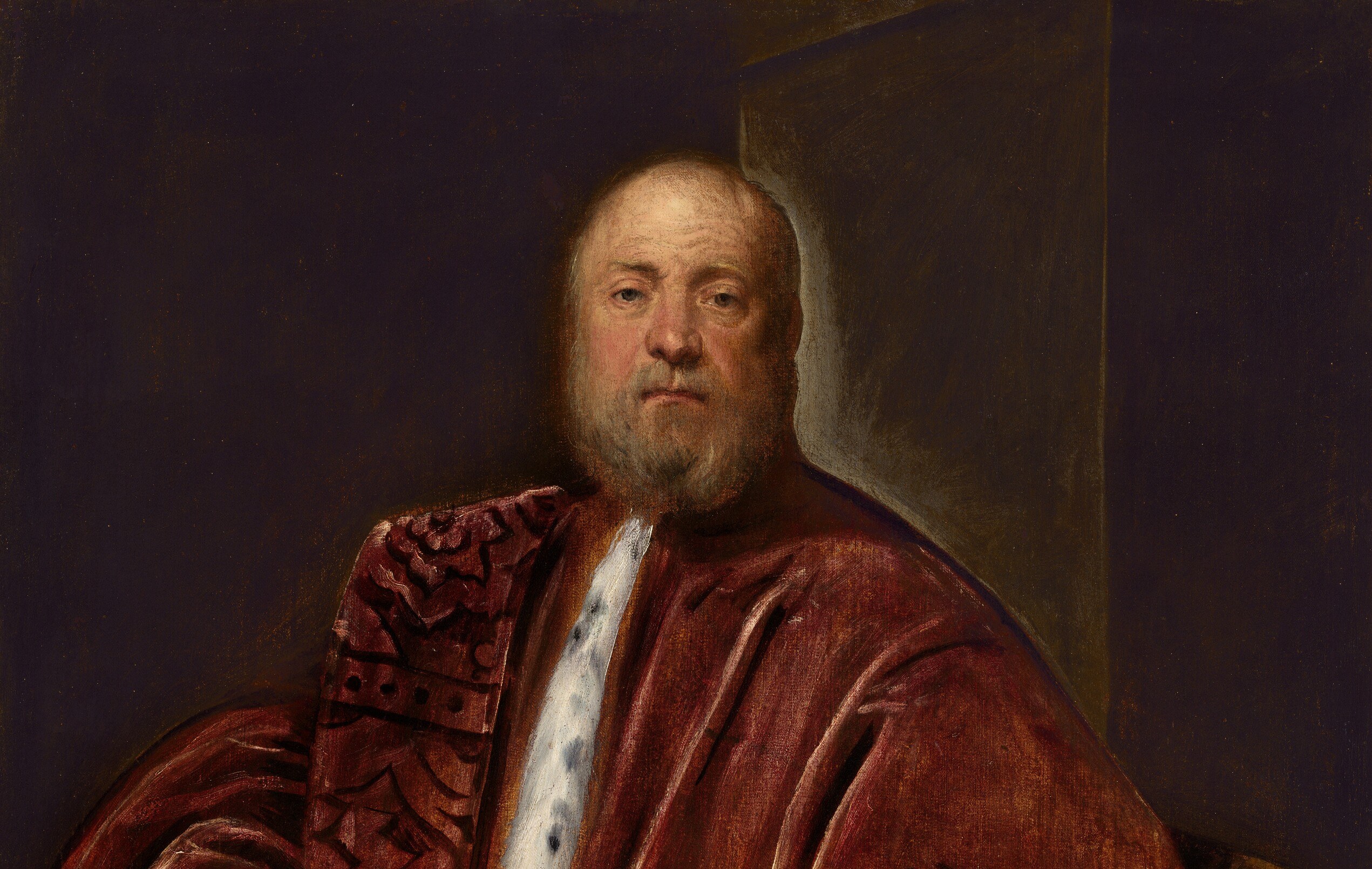 The deep, shadowy background pushes the figure forward, emphasizing his presence and the richness of his attire.