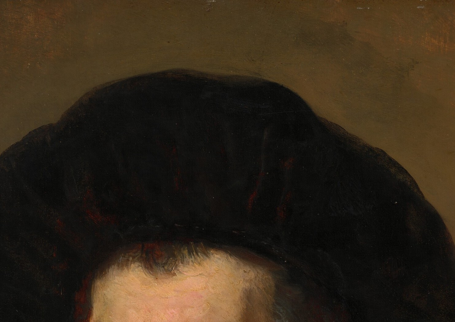 You read him as a humble thinker. Plain cap, inward gaze.