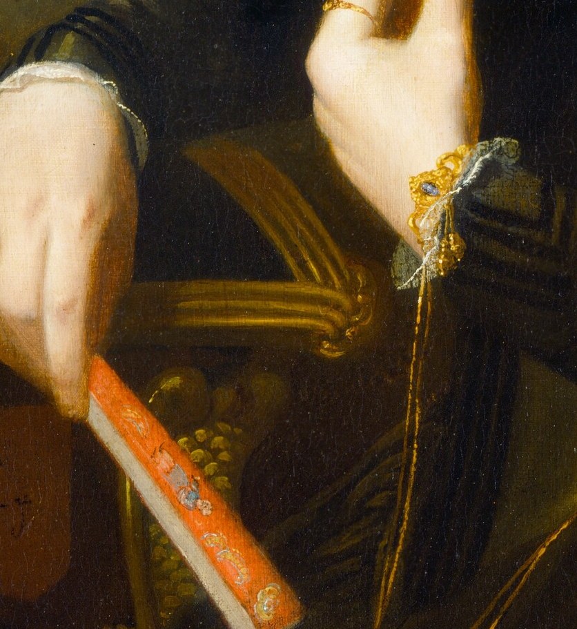 But her other hand rests near a writer's prop: a book.