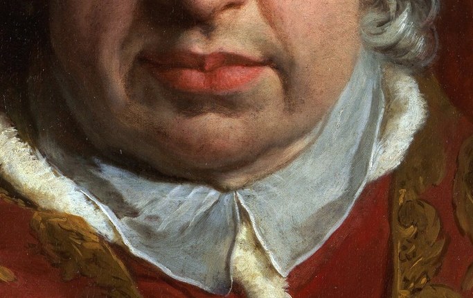 The luxurious white fur trim contrasts with the red robes, highlighting his status.