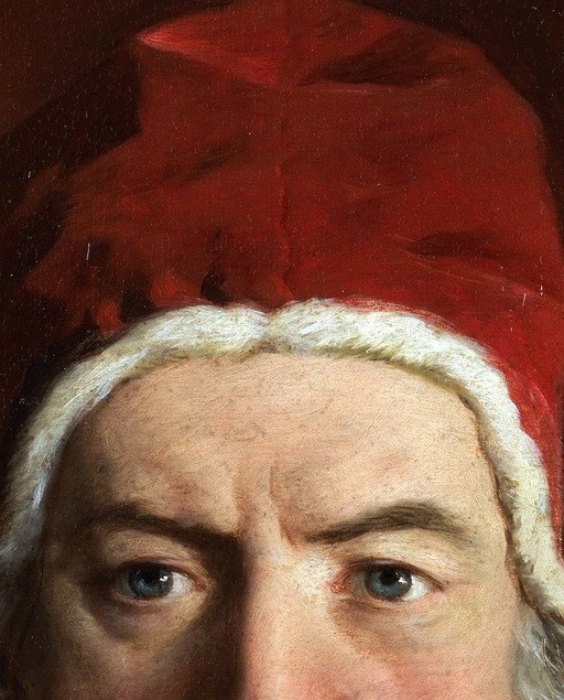 The rich red fabric and soft folds of the skullcap are rendered with a tactile quality.