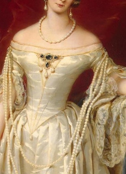 The cascading pearls add a touch of opulence and delicate femininity to her formal attire.