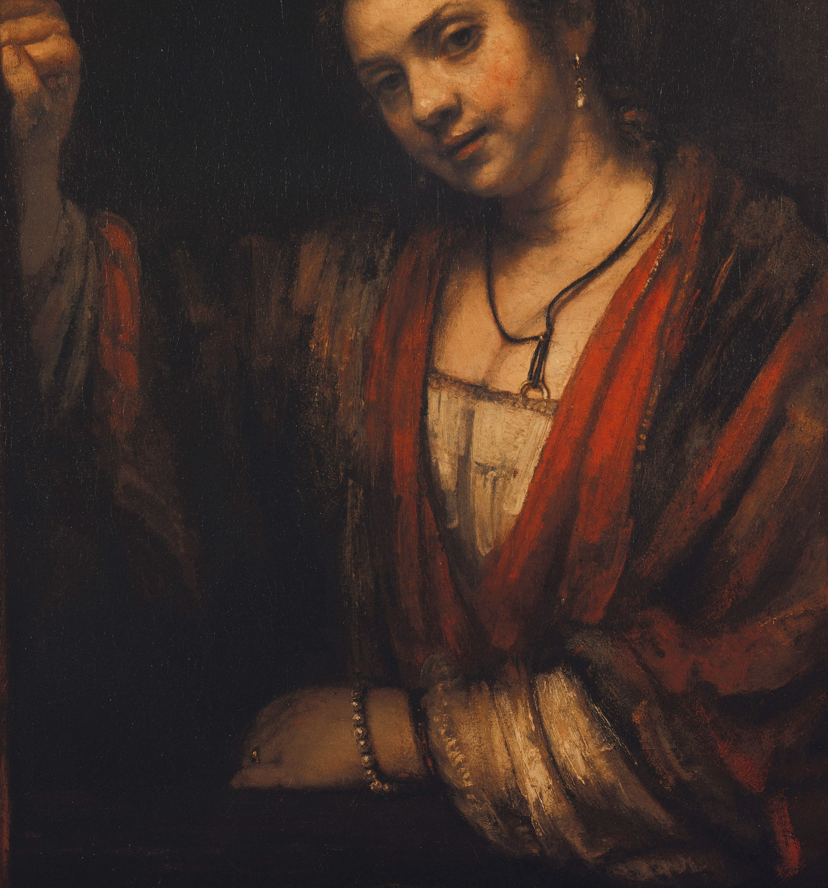 The warm ochre-red cloak is Rembrandt's dominant coloristic statement; its loose fall and visible loaded-brush strokes in the lower folds show his late impasto technique at its most confident.
