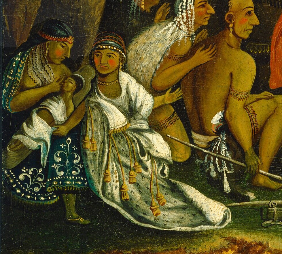 Her elaborate clothing and serene posture suggest cultural richness and a peaceful presence.