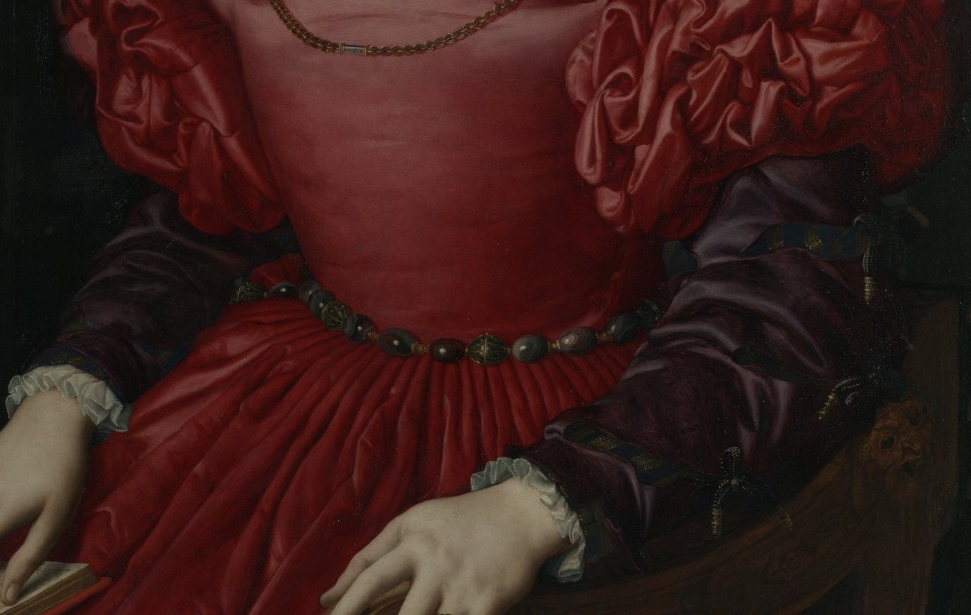 Her opulent pearls and red silk dress speak of wealth and status.
