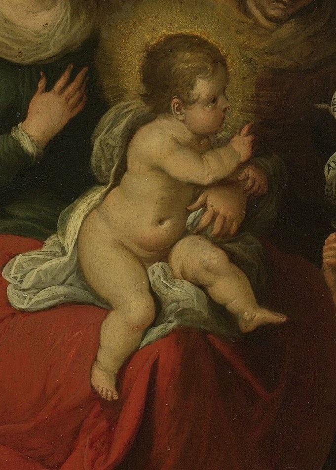 The Christ Child reaches for the symbolic Lamb of God.