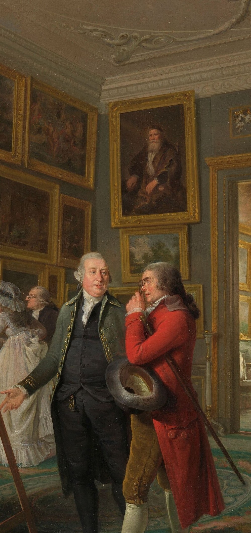 The collector-host in his distinctive red coat, actively presenting artworks to guests , the social and narrative pivot of the scene
