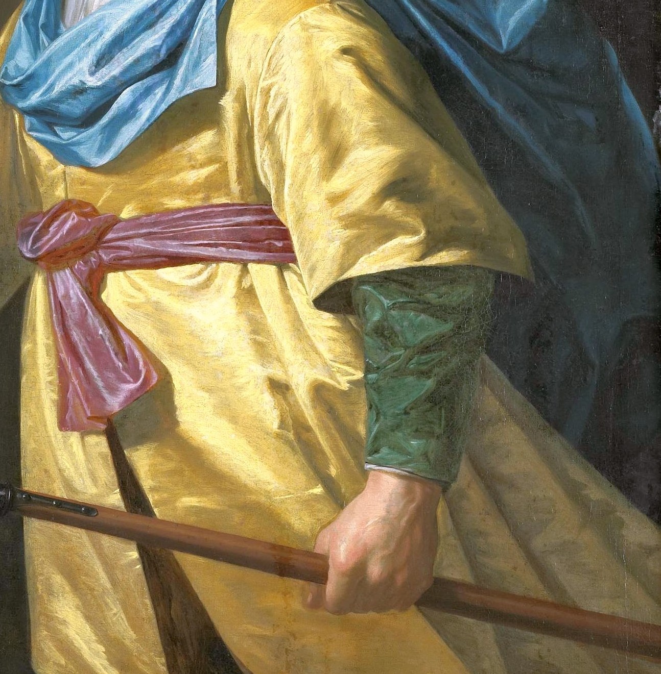 The vibrant color and rich texture of the fabric draw the eye and signify wealth and status.
