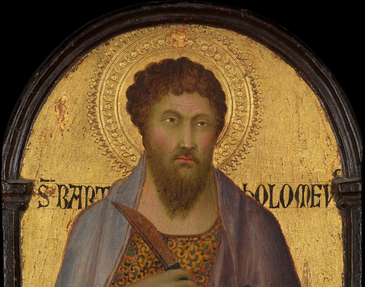 Behind him: not sky, not earth. Sacred timelessness in gold leaf.