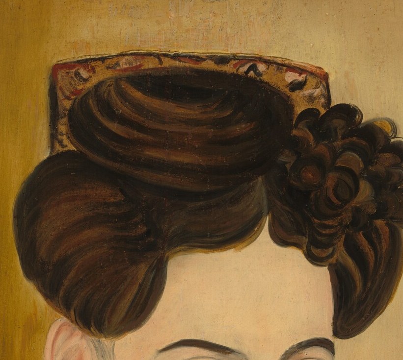 Her elaborate hairstyle shows her status and fashion of the time.