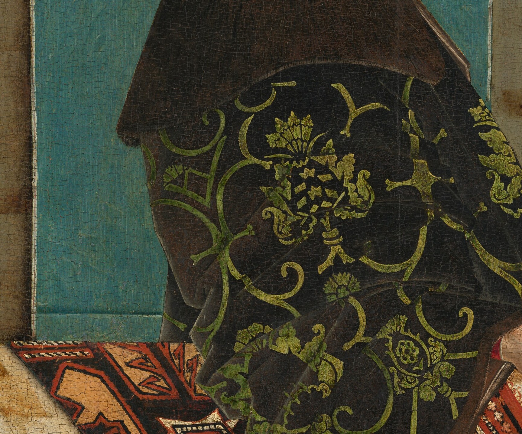 He wears crushed velvet brocade with gilt grapevines.