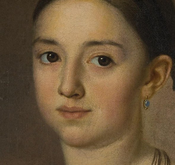 This young woman looks out with a quiet gaze.