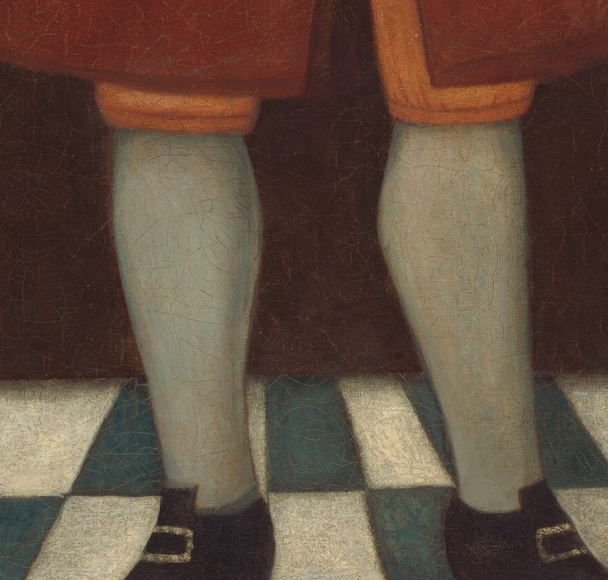 The contrast of the pale stockings against the darker floor and shoes highlights his lower legs.