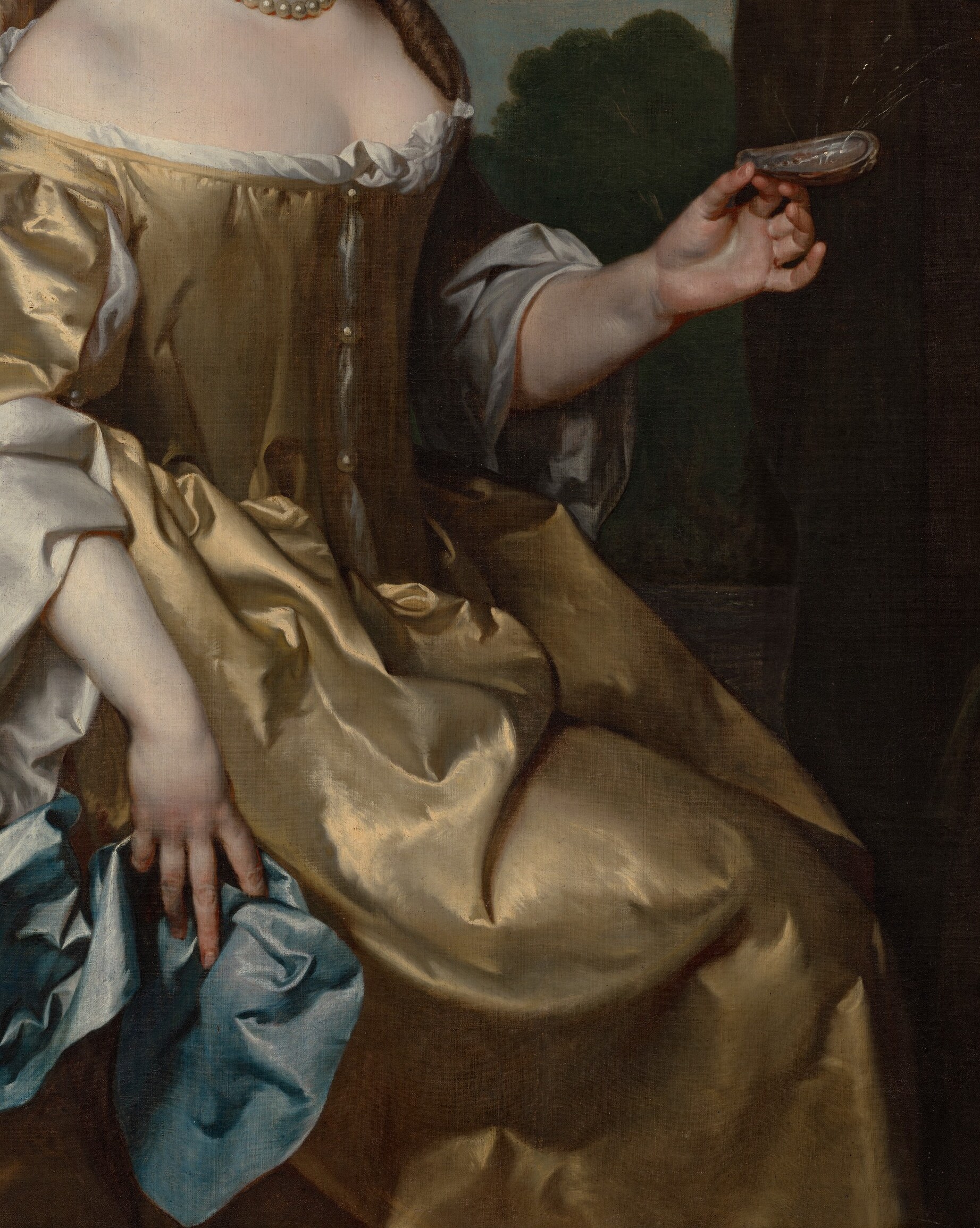 Notice her shimmering gold gown, capturing the light beautifully.