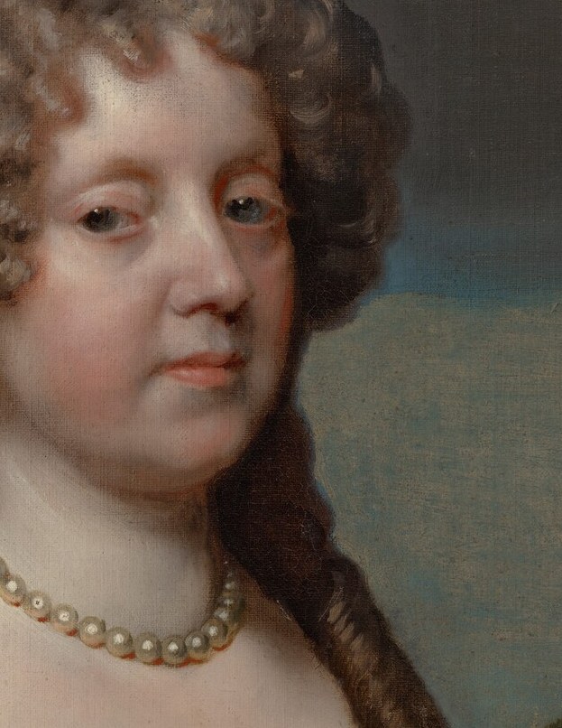 Her calm expression and elegant posture suggest a quiet dignity.