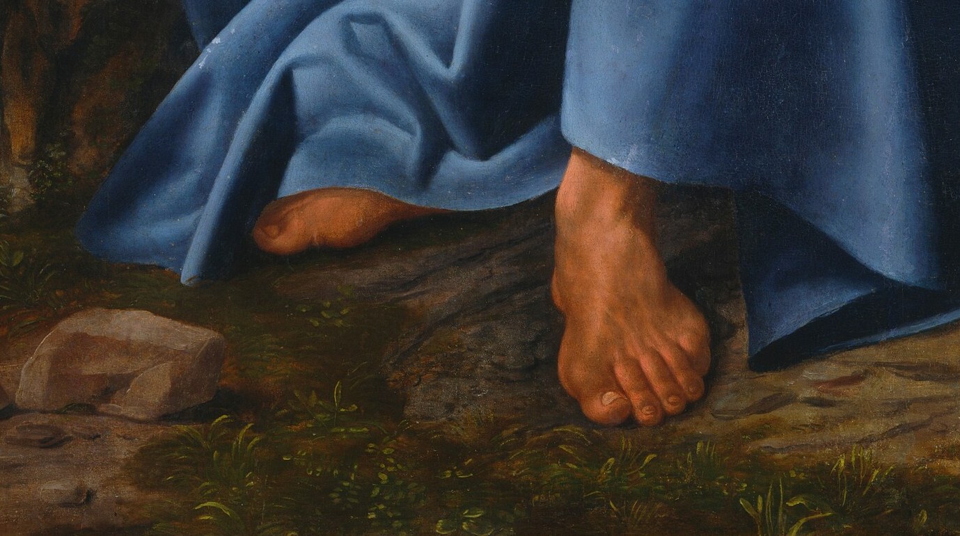 His bare feet signal holy ground and voluntary poverty.