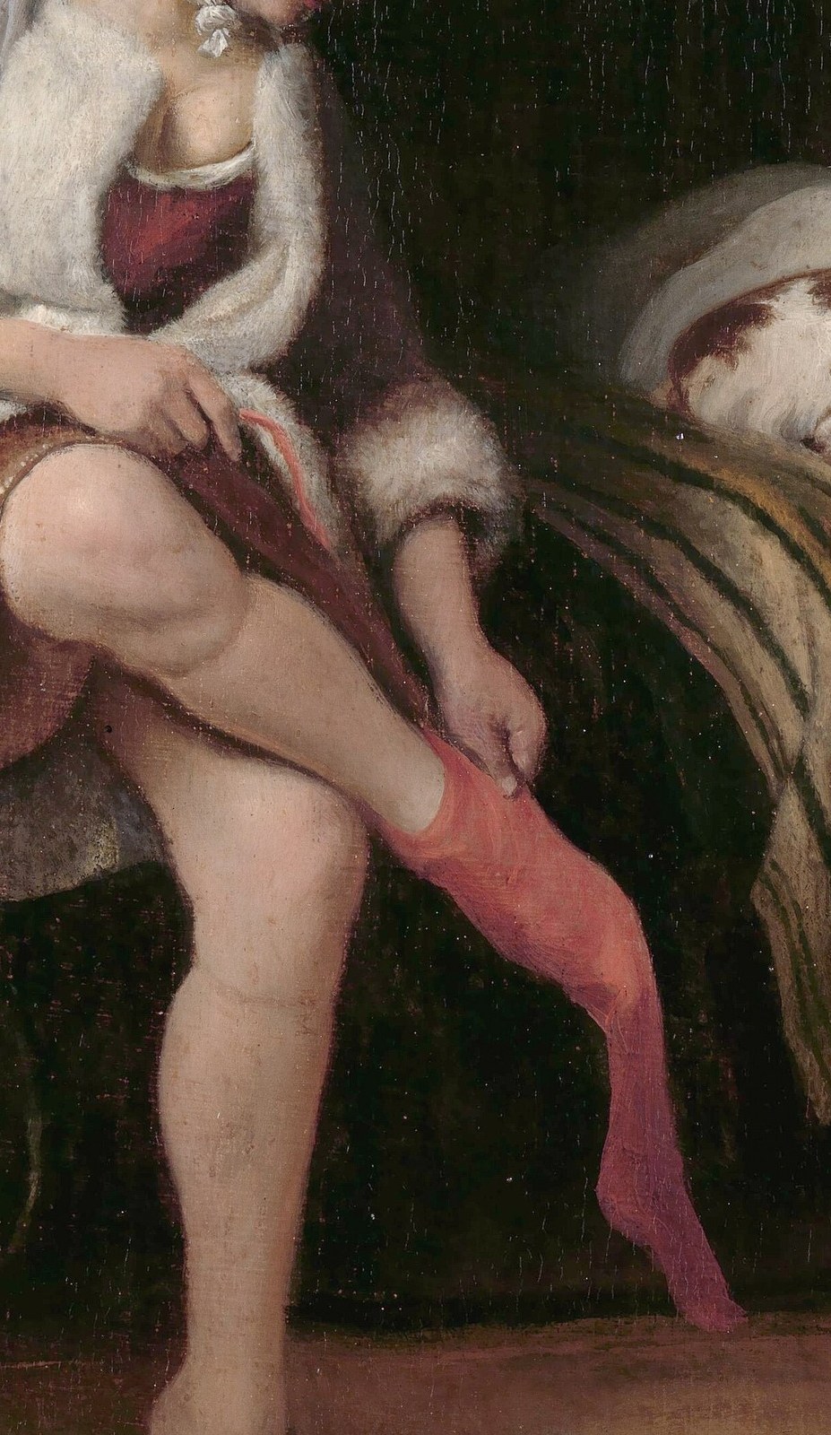 She is pulling on a pink stocking.