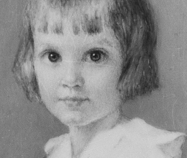 Her gaze is direct, with a serious expression beyond her years.