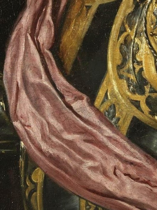 A pink sash contrasts with the armor.