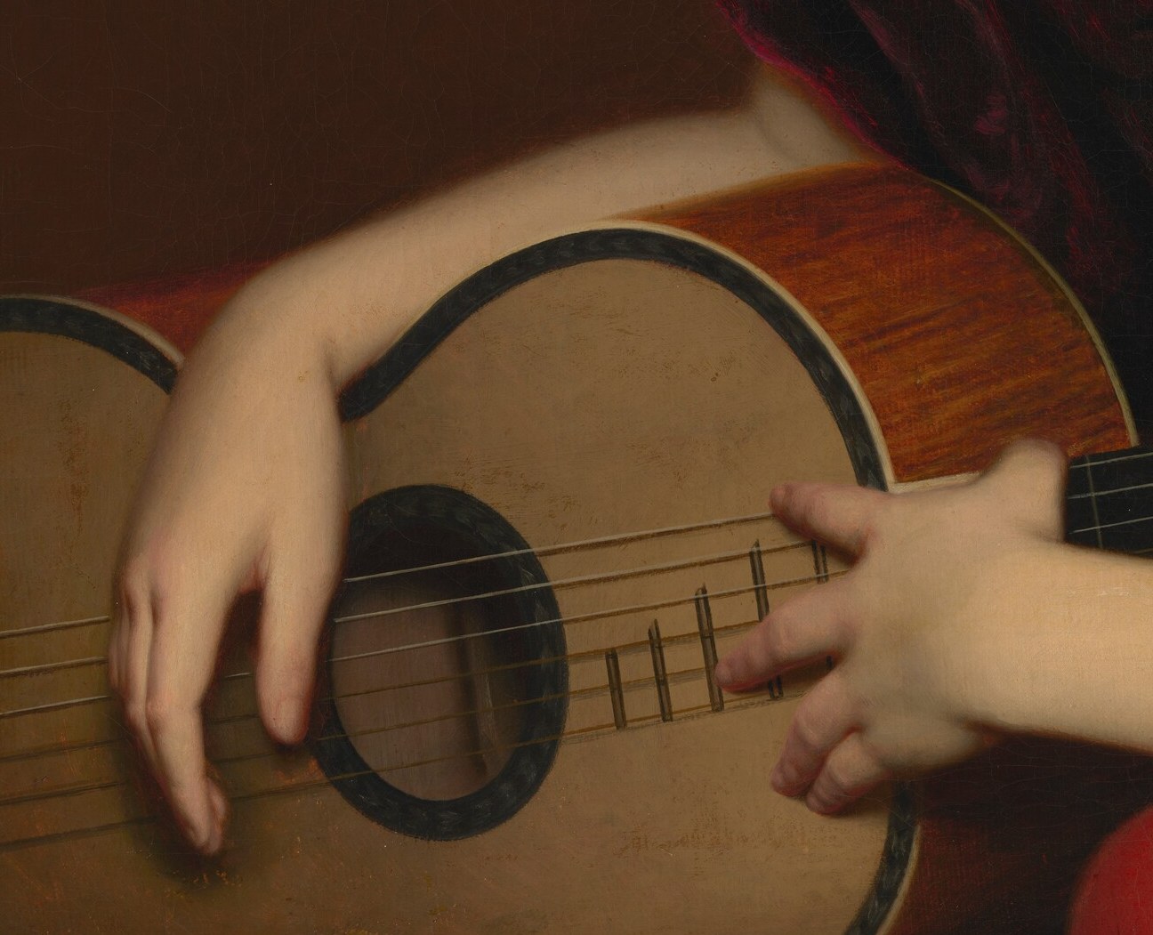 Her fingers rest on the strings, ready to play.