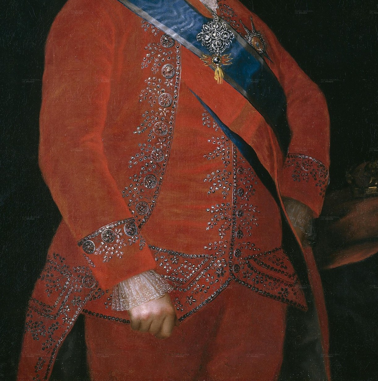 His red ceremonial robe signifies his importance.