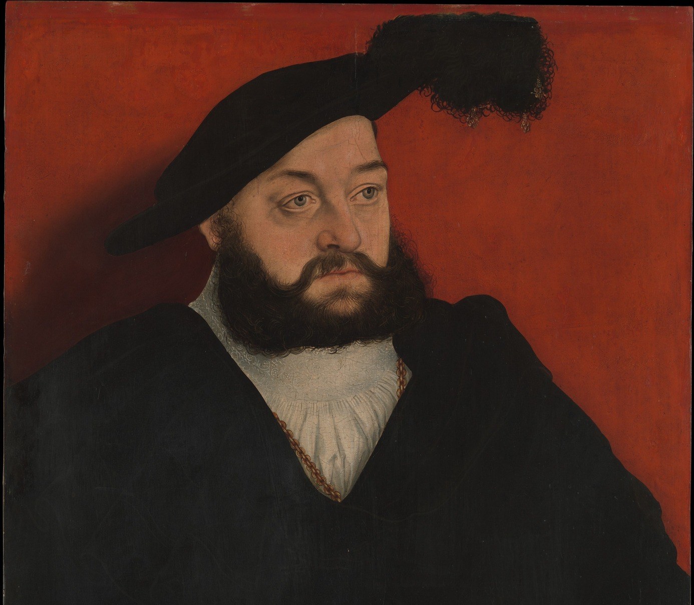 Cranach's signature device: a saturated monochrome ground that strips away spatial ambiguity and focuses attention entirely on the sitter , a deliberate painterly trick worth examining closely