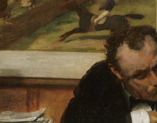 He keeps his head bent, focused on his papers.