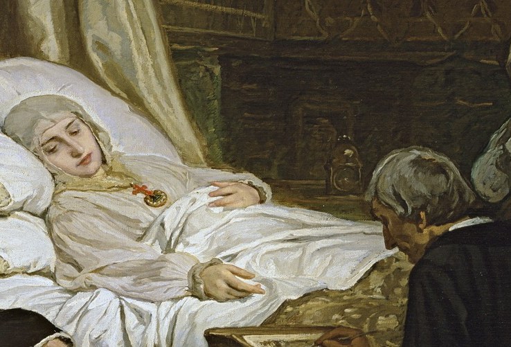 She lies in bed, pale and serene.